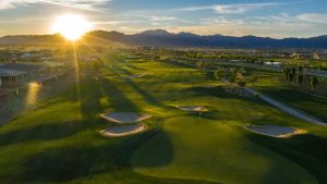 Manicured golf course with sun rising in the background. 