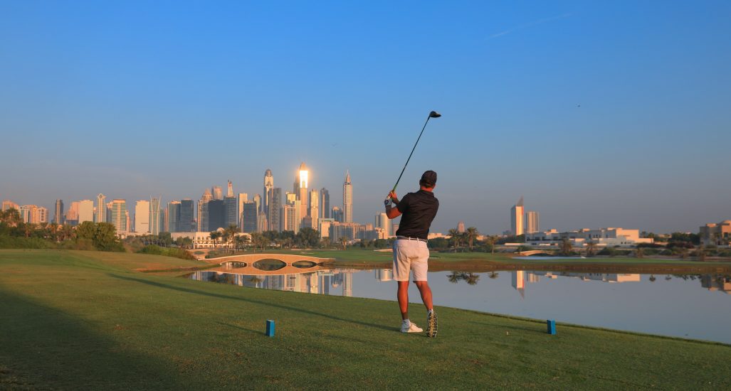 Golfer on the tee of the 18th at Montgomerie Golf Club Dubai