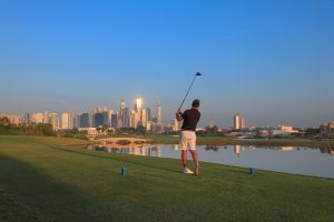 Golfer on the tee of the 18th at Montgomerie Golf Club Dubai