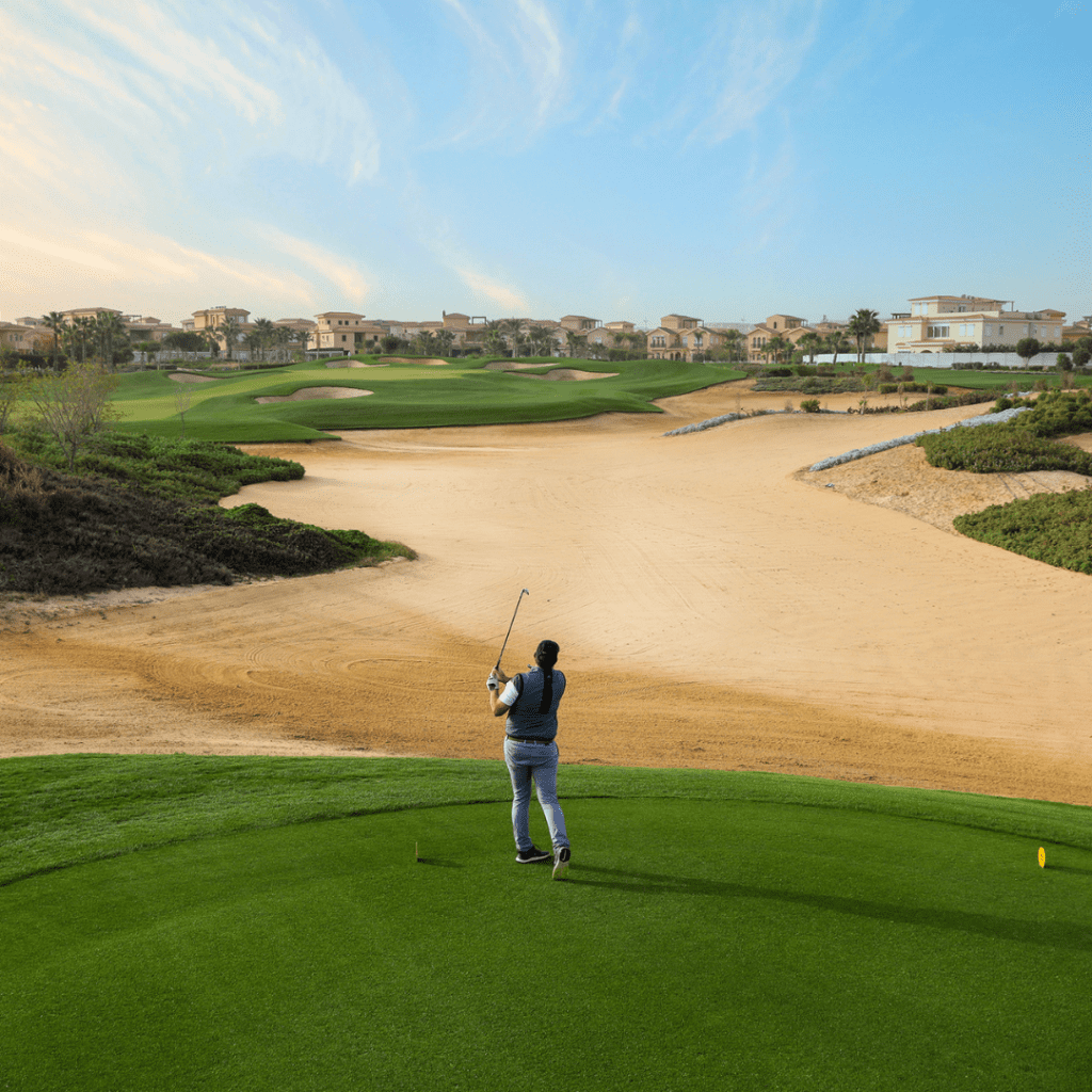 Golfer teeing off at Madinaty Golf Club