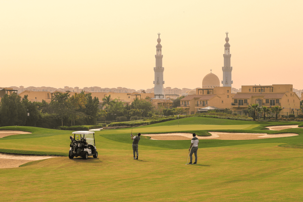 Two golfers on the course at Madinaty Golf Club