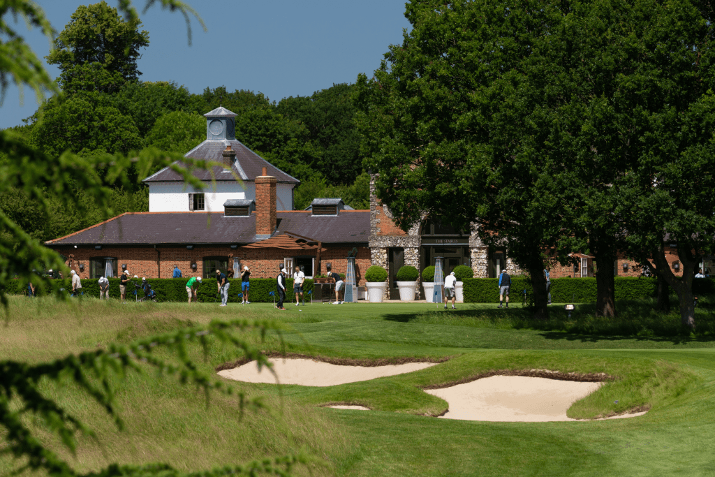 Golfers on the putting green at The Grove