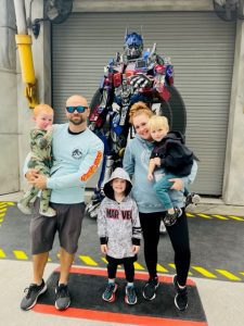 Danielle Enyeart and Family taking picture in front of Optimus Prime of the Transformers