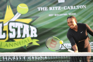 Venus Williams hitting a tennis ball over a net