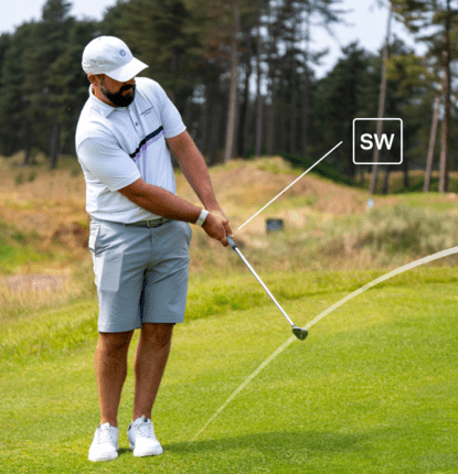 Man hitting sand wedge shot